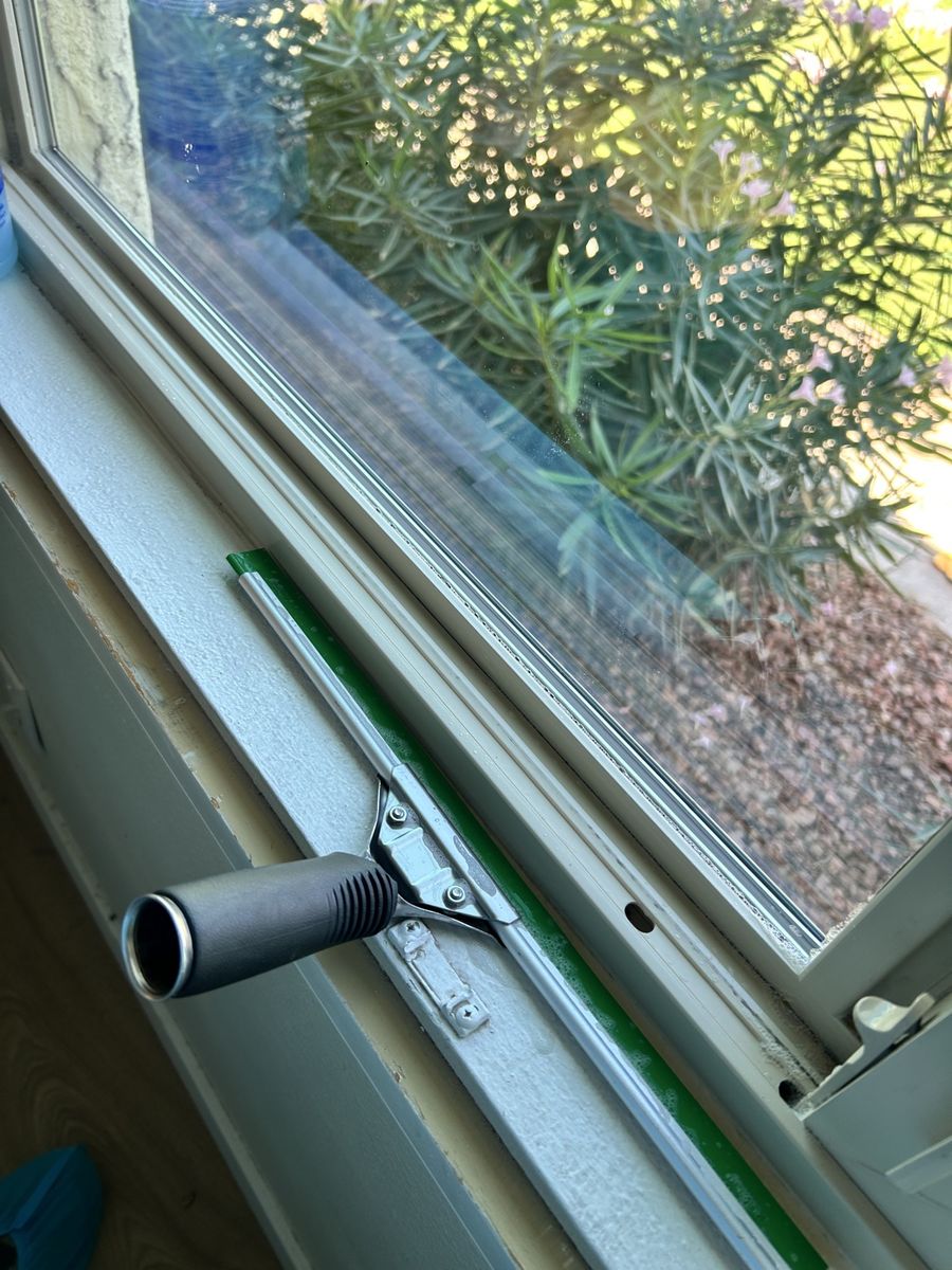 Squeegee detailing a window track in Phoenix AZ