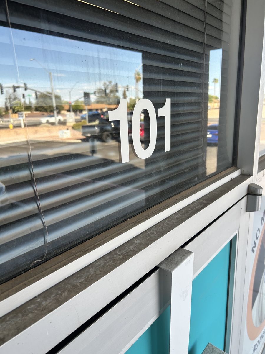 Dirty commercial storefront window before cleaning